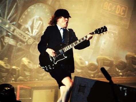 What Guitar Does Angus Young Play: A Symphony of Strings and Shadows